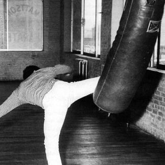 Bruce Lee workout kicking heavy bag